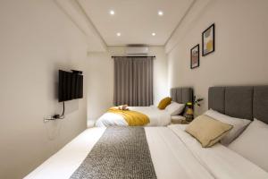 Postel nebo postele na pokoji v ubytování 單眼皮民宿 Single Eyelid Hostel