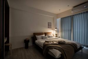Postel nebo postele na pokoji v ubytování 單眼皮民宿 Single Eyelid Hostel