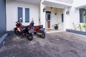 a motorcycle parked in front of a house at OYO 2975 House Of Mahira Syariah in Ciamis
