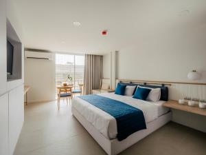 a bedroom with a large bed with blue pillows at BLU 395 Ari-Saphan Khwai in Bangkok