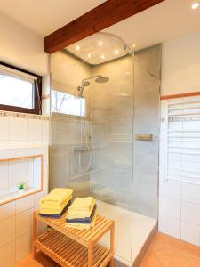 a bathroom with a shower and a table with towels at Ferienwohnung Isabella am Möhnesee in Möhnesee