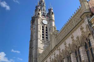 a clock tower on the side of a building at Studio de charme en centre ville D1 in Douai