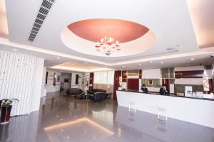 a lobby with a reception desk and a chandelier at Yoyo Hotel in Chiayi City