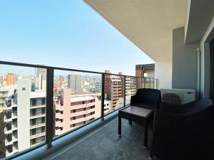 a balcony with a view of a city at Randor Residential Hotel Fukuoka Annex in Fukuoka
