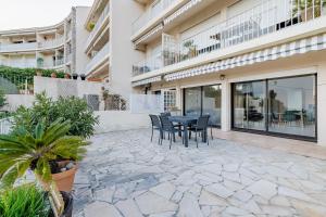 a patio with a table and chairs in front of a building at Le Verdesco par Dodo-a-Cassis in Cassis