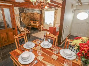 a dining room with a wooden table and chairs at Ffynnondici Farmhouse in Fishguard