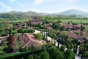 an aerial view of a resort with trees and houses at Borgo Santo Pietro in Chiusdino
