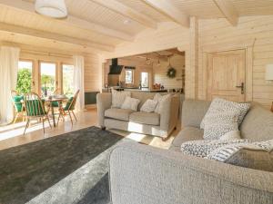 a living room with two couches and a dining room at Gardener's Lodge in York