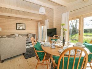 a dining room with a table and chairs and a couch at Gardener's Lodge in York