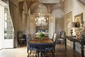a dining room with a table and a chandelier at Borgo Santo Pietro in Chiusdino