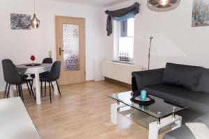 a living room with a couch and a table at FeWo Bucker in Lauscha