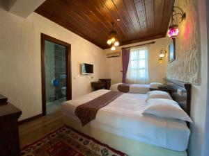 a bedroom with two large beds in a room at Cicerone Lodge Hotel in Antalya