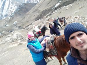 a group of people on a mountain with a pony at Xinaliq Khinalig ELNUR GUEST HOUSE, New hotel in Xınalıq