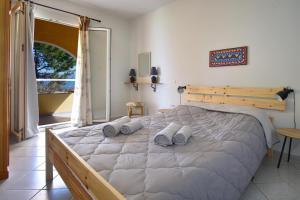 a bedroom with a large bed with pillows on it at Villa By The Sea - Βίλα Πάνω στη θάλασσα in Kavos