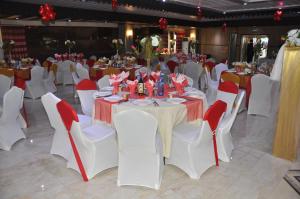 a banquet hall with white tables and white chairs at Sun Beach Hôtel in Cotonou