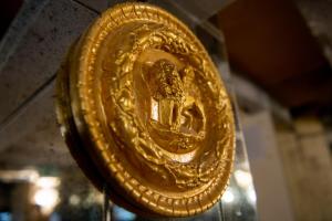 a gold medal is hanging on a wall at Ca Dell'Arte in Venice