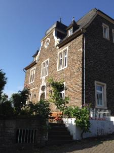 an old brick building with a clock on it at Haus Nummer 1, Moselblick in Reil