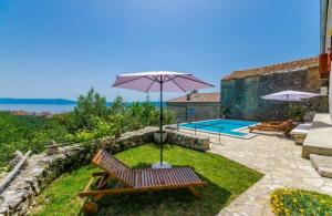 een patio met een bank, een parasol en een zwembad bij Holiday Residence Sarar Kotor in Crikvenica