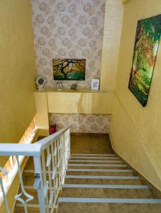a staircase in a house with a painting on the wall at Floare de Iris in Vama Veche