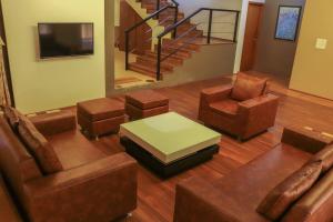 a living room with chairs and a table and a staircase at Surya Kiran Miramar in Panaji