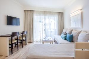 a living room with a couch and a table at Grupotel Los Príncipes & Spa in Playa de Muro