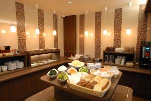 a buffet line with bowls of food on a table at AB Hotel Toyohashi in Toyohashi