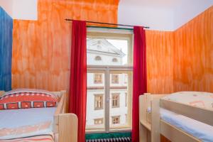 a bedroom with two bunk beds and a window at Best Spot Hostel in Prague