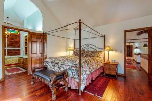 a bedroom with a canopy bed and a mirror at Wayne Creek Residence in Avon