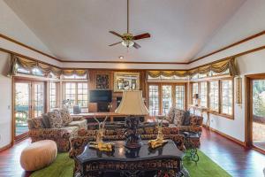 a living room with a couch and a ceiling fan at Wayne Creek Residence in Avon