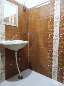 a bathroom with a sink and a shower at Maji Homestay Khajuraho in Khajurāho