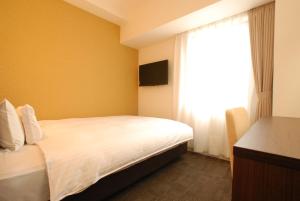 Postel nebo postele na pokoji v ubytování AB Hotel Isesaki