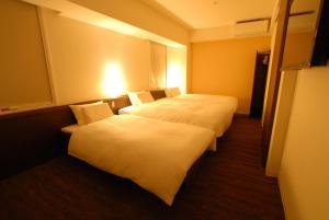 Postel nebo postele na pokoji v ubytování AB Hotel Isesaki