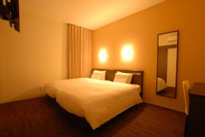 Postel nebo postele na pokoji v ubytování AB Hotel Isesaki