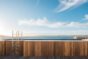 a wooden fence with a view of the ocean at Les Bords De Mer in Marseille