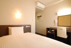 Ένα ή περισσότερα κρεβάτια σε δωμάτιο στο AB Hotel Gifu