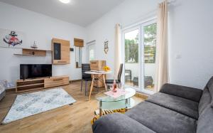 a living room with a couch and a table at Villa HEIDI in Umag