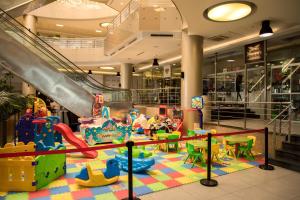 an indoor play area with a slide in a mall at Kin Plaza Arjaan by Rotana in Kinshasa