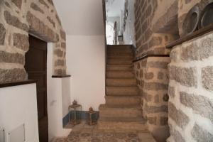 a staircase in a building with a brick wall at Casa Lu Duttori in Arzachena
