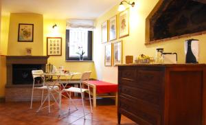 a kitchen with a table and chairs and a dining room at Il Peperino GuestHouse in Viterbo