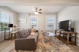 a living room with a couch and a flat screen tv at Stunning Waco Downtown Apartments in Waco