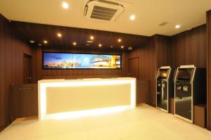 a room with a flat screen tv on the wall at AB Hotel Tokai Otagawa in Tokai
