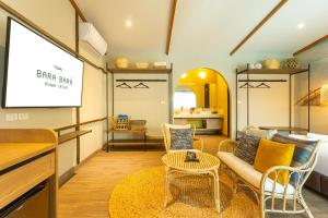 a living room with a projector screen and a couch at BARA BARA' Budget SATUN 'SHA Plus' in Satun