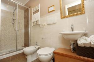 a bathroom with a toilet and a sink and a shower at DG Prestige Room in Rome