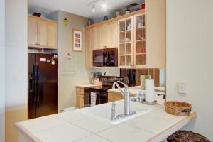 a kitchen with a sink and a refrigerator at Beachwalk Villas 23 in Folly Beach
