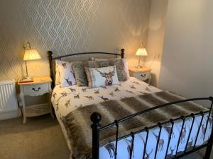 a bedroom with a bed with birds on the sheets at The Westbourne Guest House in Llandudno