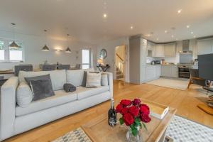 sala de estar con sofá y mesa con rosas en Westaway, en Portreath