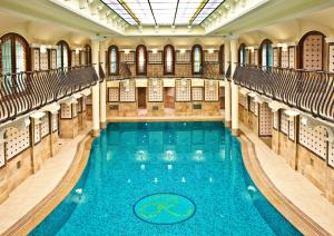 a swimming pool in a building with a ceiling at Corinthia Budapest in Budapest