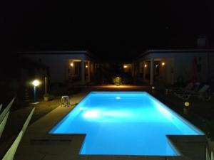 a swimming pool lit up at night at Casa Zanzibar Hotel in Landeira