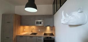 a kitchen with a statue of a rhino head on the wall at La Folie Hubert in Meung-sur-Loire