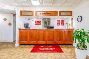 a waiting room with a cash counter and a red rug at Econo Lodge in Martinsville